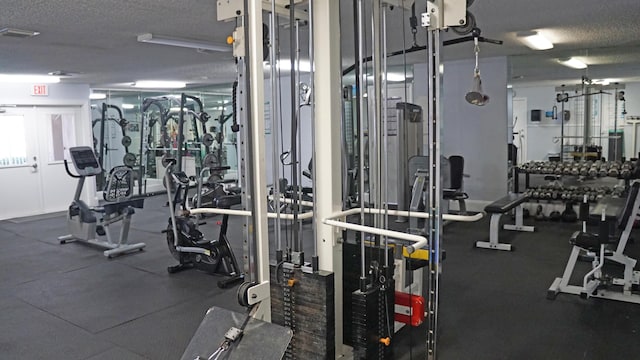 gym with a textured ceiling and visible vents