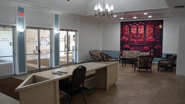 office with tile patterned flooring, visible vents, a tray ceiling, built in desk, and an inviting chandelier