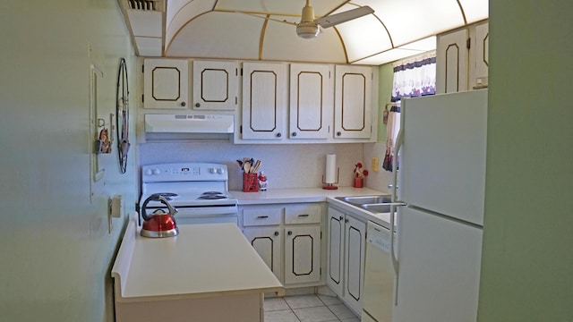 kitchen with light countertops, white appliances, light tile patterned flooring, and under cabinet range hood