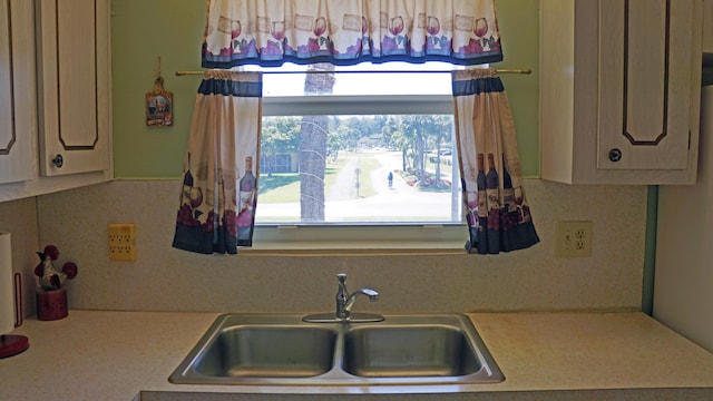 kitchen featuring light countertops and a sink