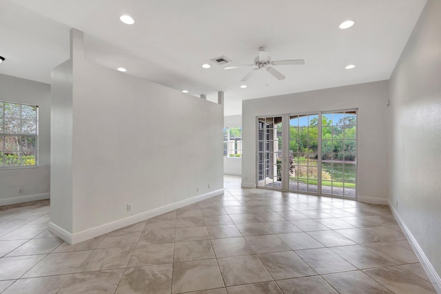 empty room featuring light tile patterned flooring, recessed lighting, a ceiling fan, visible vents, and baseboards