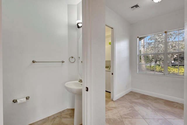 bathroom featuring tile patterned flooring, visible vents, and baseboards