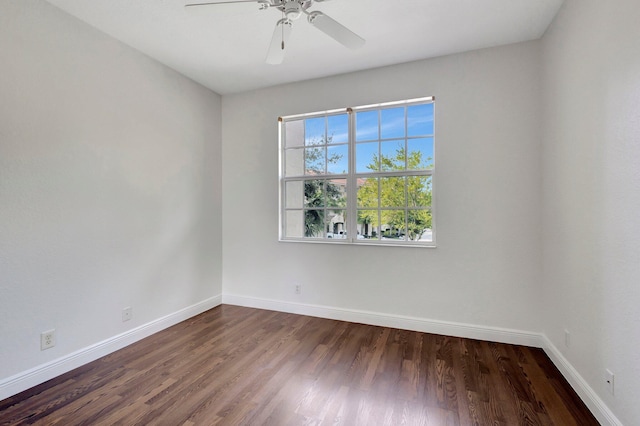 spare room with ceiling fan, baseboards, and wood finished floors