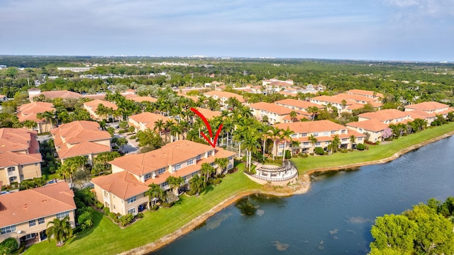 drone / aerial view featuring a water view and a residential view