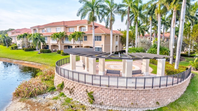 exterior space with a water view and a lawn