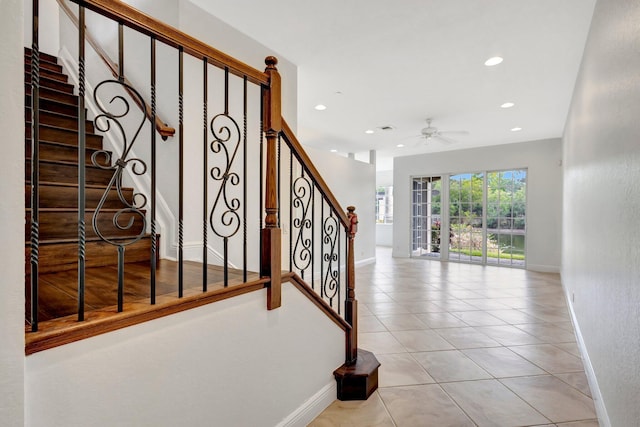 stairway featuring tile patterned flooring, baseboards, a ceiling fan, and recessed lighting