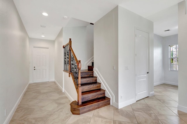 stairway with recessed lighting and baseboards