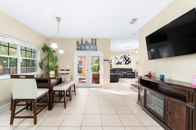 dining area with a wealth of natural light, french doors, visible vents, and light tile patterned floors