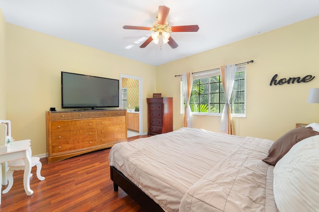 bedroom featuring wood finished floors, a ceiling fan, and baseboards