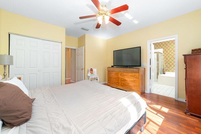 bedroom featuring baseboards, visible vents, ceiling fan, wood finished floors, and a closet
