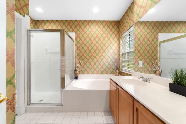 bathroom with a garden tub, vanity, a shower stall, tile patterned floors, and wallpapered walls