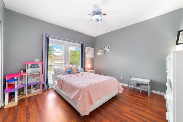 bedroom with wood finished floors, a ceiling fan, and baseboards