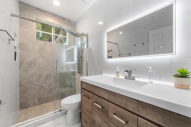 bathroom featuring marble finish floor, a stall shower, vanity, and toilet