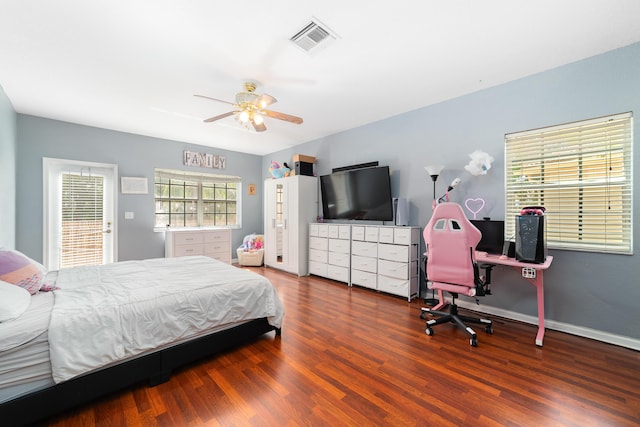 bedroom featuring a ceiling fan, baseboards, visible vents, and wood finished floors