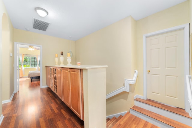 interior space featuring dark wood-style floors, visible vents, and baseboards