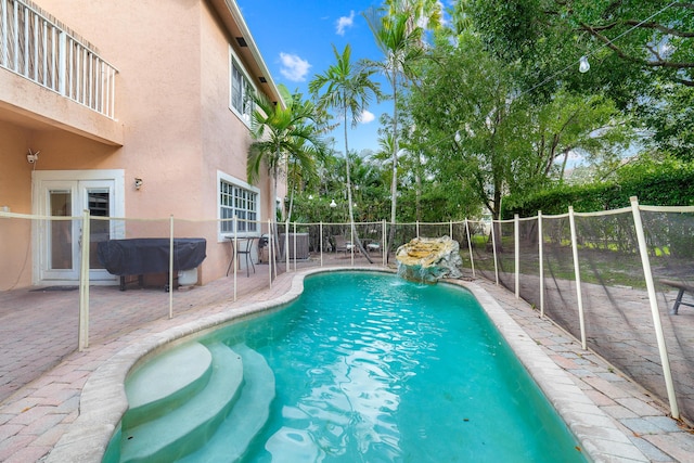 view of pool featuring a patio area, fence, and a fenced in pool