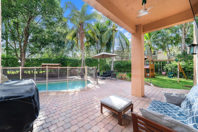 view of patio featuring a playground, a fenced backyard, area for grilling, and an outdoor hangout area