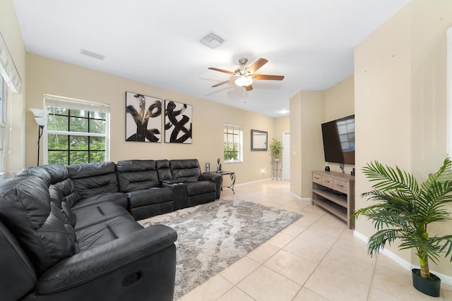 living room featuring a ceiling fan, light tile patterned flooring, visible vents, and baseboards