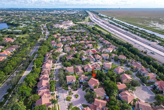 birds eye view of property featuring a water view and a residential view