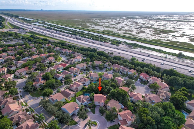 bird's eye view featuring a water view and a residential view