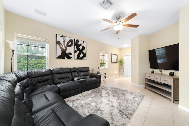 living room featuring ceiling fan, light tile patterned flooring, visible vents, and baseboards