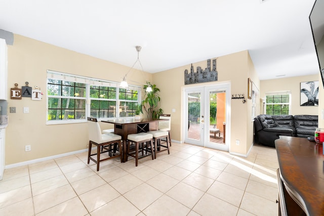 dining room with light tile patterned floors, baseboards, and french doors