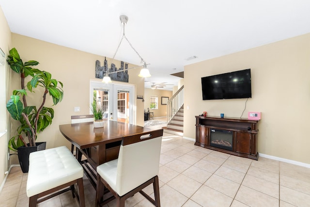 dining area with light tile patterned floors, stairs, baseboards, and french doors