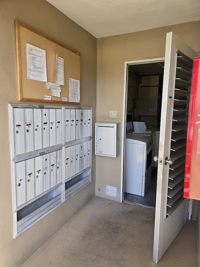 view of property's community with washing machine and dryer and mail area