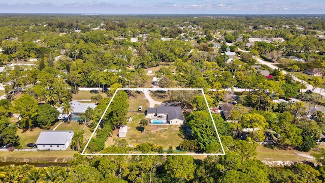 birds eye view of property with a wooded view