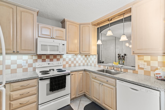 kitchen featuring light brown cabinetry, white appliances, a sink, and decorative backsplash