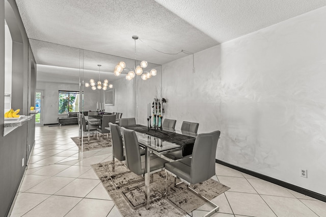 dining room with baseboards, a textured ceiling, an inviting chandelier, and light tile patterned floors