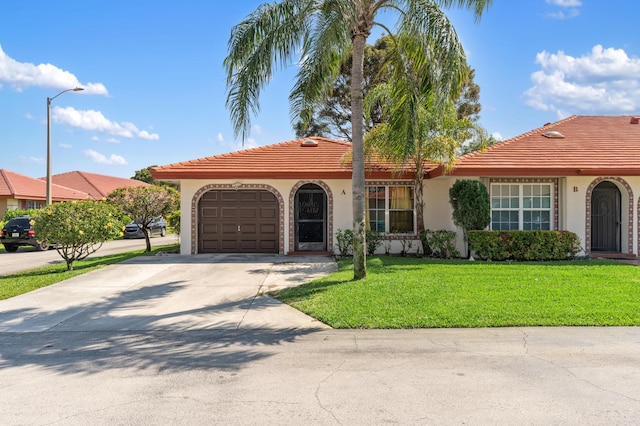 view of front of house featuring a garage, concrete driveway, a tiled roof, a front lawn, and stucco siding