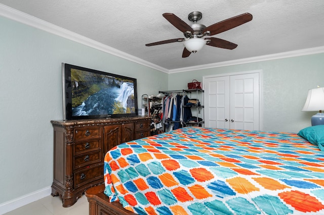 bedroom featuring ceiling fan, ornamental molding, a textured ceiling, and tile patterned floors