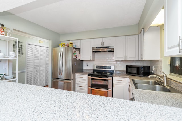 kitchen featuring stainless steel appliances, white cabinetry, a sink, and under cabinet range hood