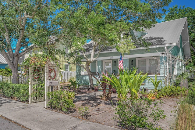 view of front of house featuring a porch and fence