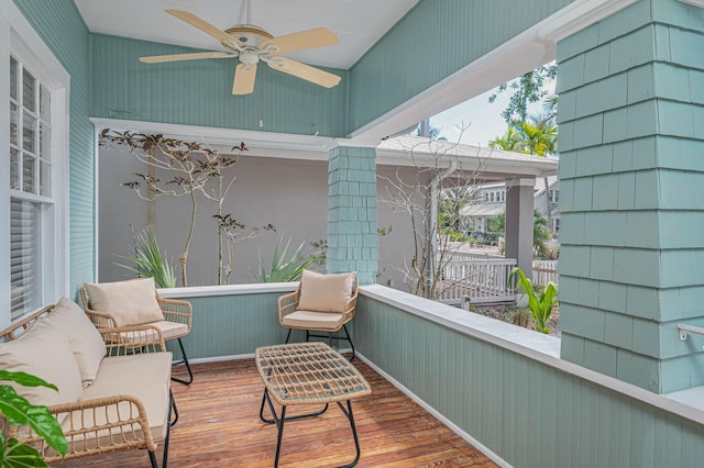 sunroom featuring a ceiling fan