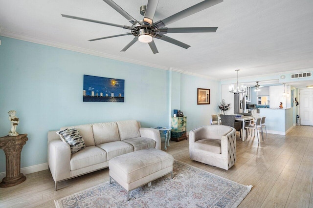 living area with crown molding, visible vents, light wood-type flooring, baseboards, and ceiling fan with notable chandelier