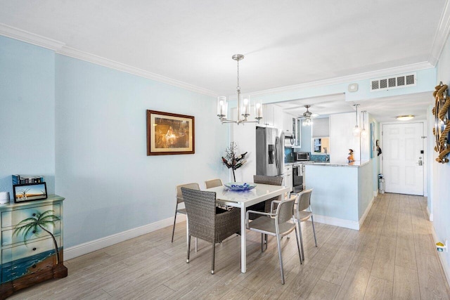 dining space featuring crown molding, a notable chandelier, visible vents, light wood-type flooring, and baseboards