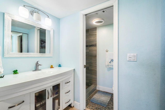 bathroom with visible vents, vanity, and baseboards