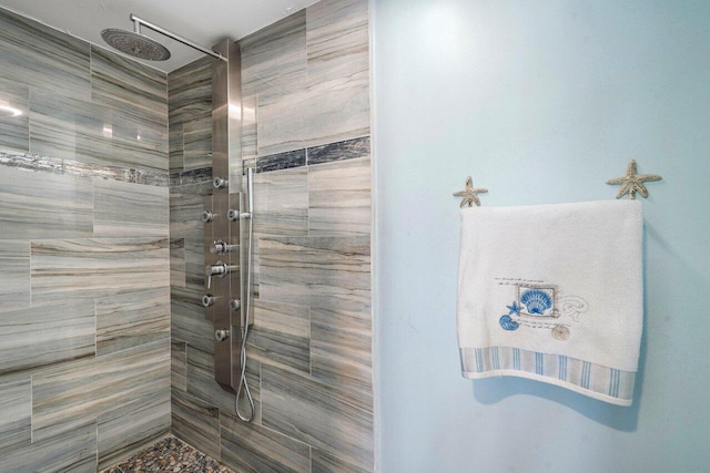 full bath featuring tiled shower