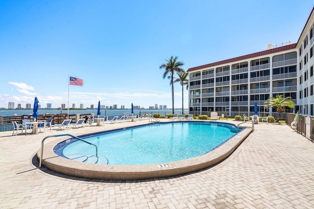 pool featuring a view of city and a patio