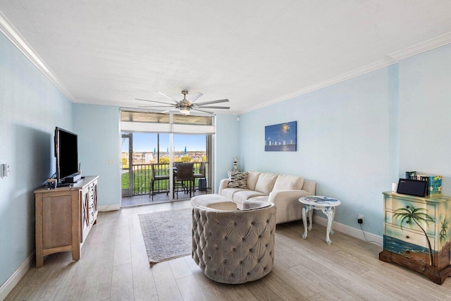 living room with light wood finished floors, ceiling fan, ornamental molding, and baseboards