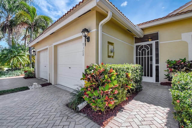 garage featuring decorative driveway