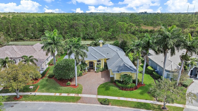 drone / aerial view featuring a forest view