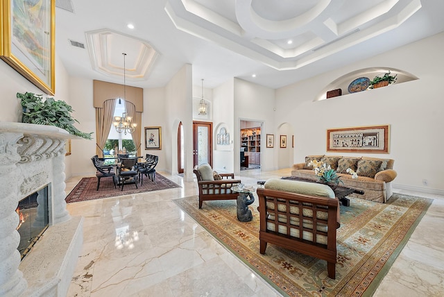 interior space featuring arched walkways, a stone fireplace, a high ceiling, visible vents, and baseboards