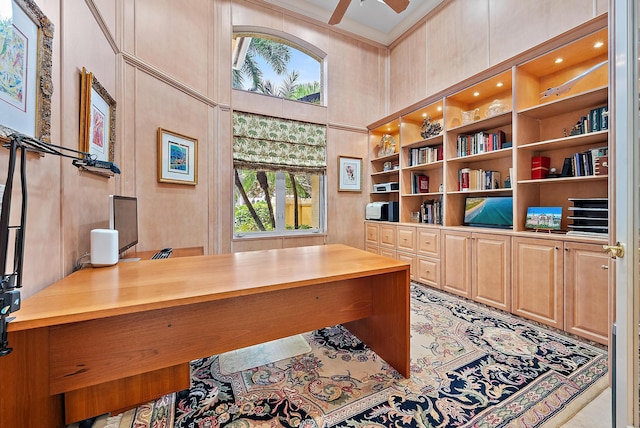 home office with a high ceiling, a wealth of natural light, and a ceiling fan