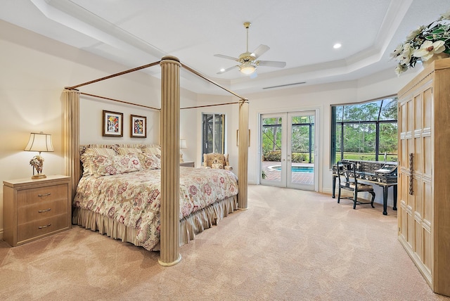 bedroom featuring light carpet, access to exterior, a raised ceiling, and french doors