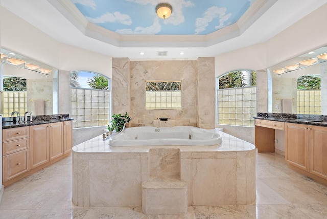 full bathroom with a jetted tub, a tray ceiling, and ornamental molding