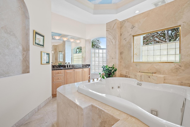 full bath featuring visible vents, vanity, baseboards, tile patterned floors, and a whirlpool tub