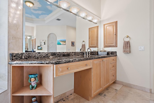 bathroom featuring baseboards, visible vents, and vanity